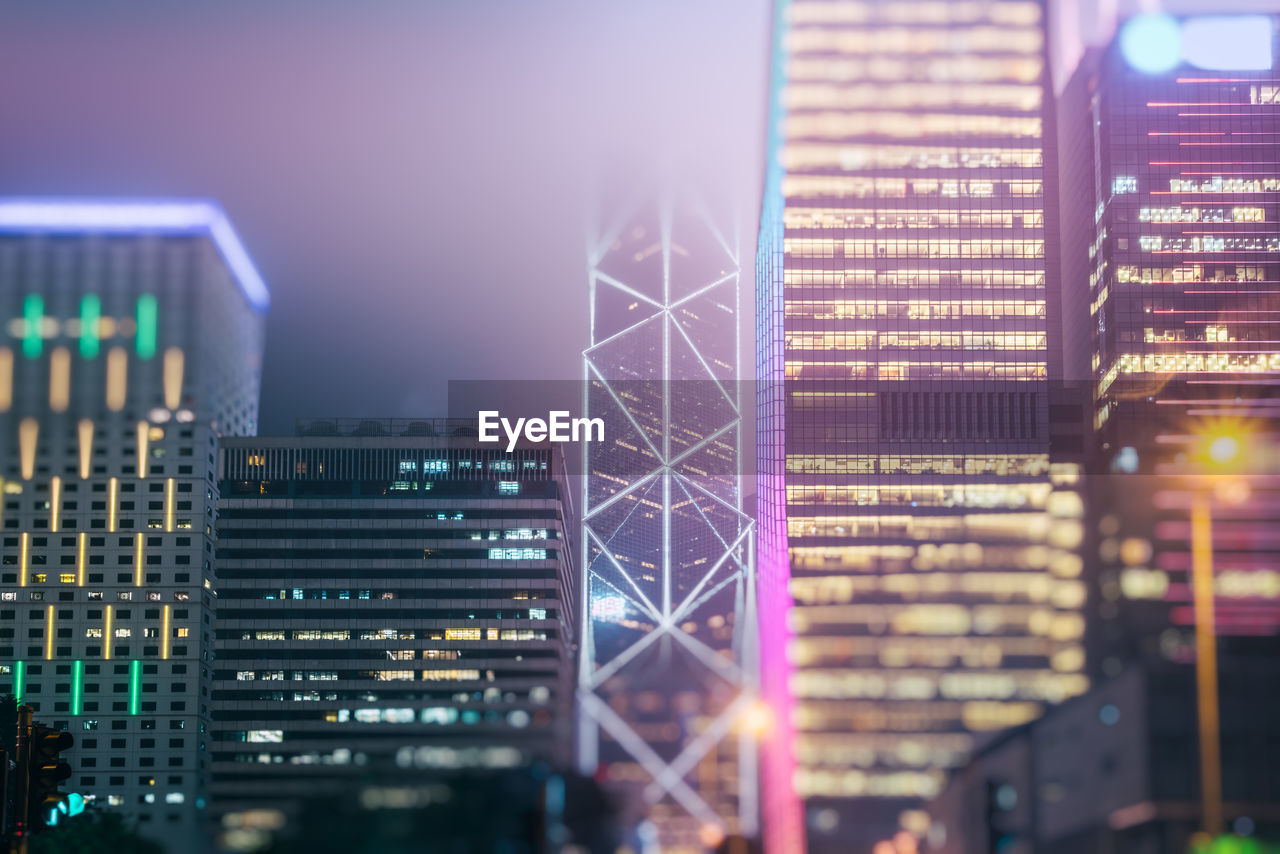 ILLUMINATED MODERN BUILDINGS AT NIGHT