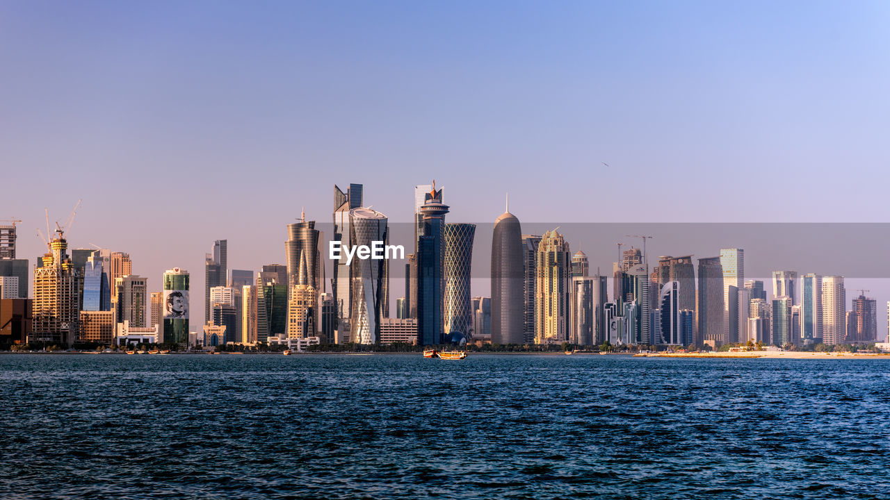 Sea with skyscrapers in background