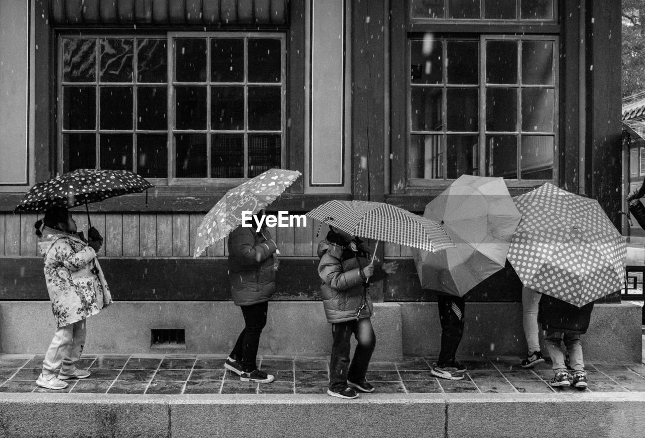 PEOPLE IN RAIN ON RAINY SEASON