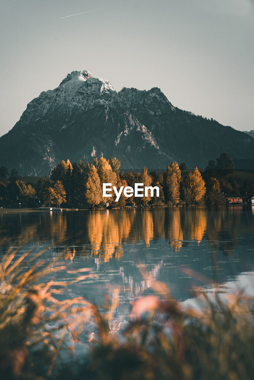 Scenic view of lake and mountains against clear sky