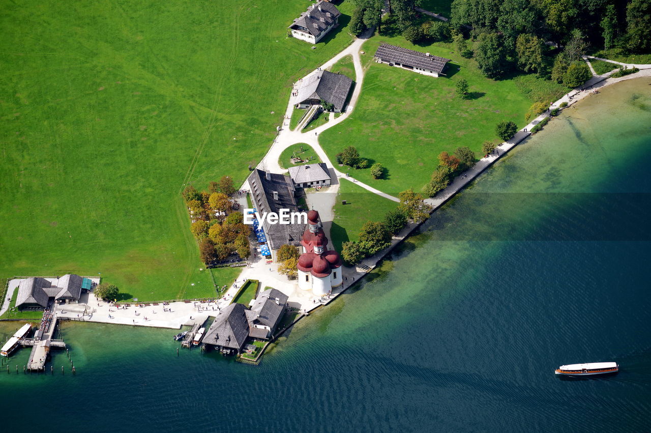 High angle view of buildings by sea in town