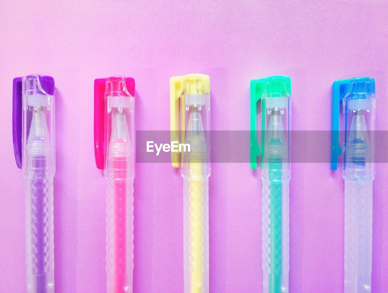 Close-up of colorful pens on table