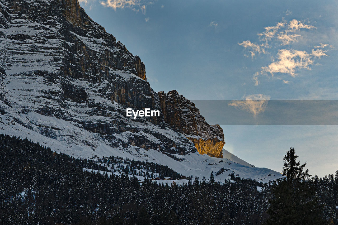 Low angle view of snowcapped mountain against sky