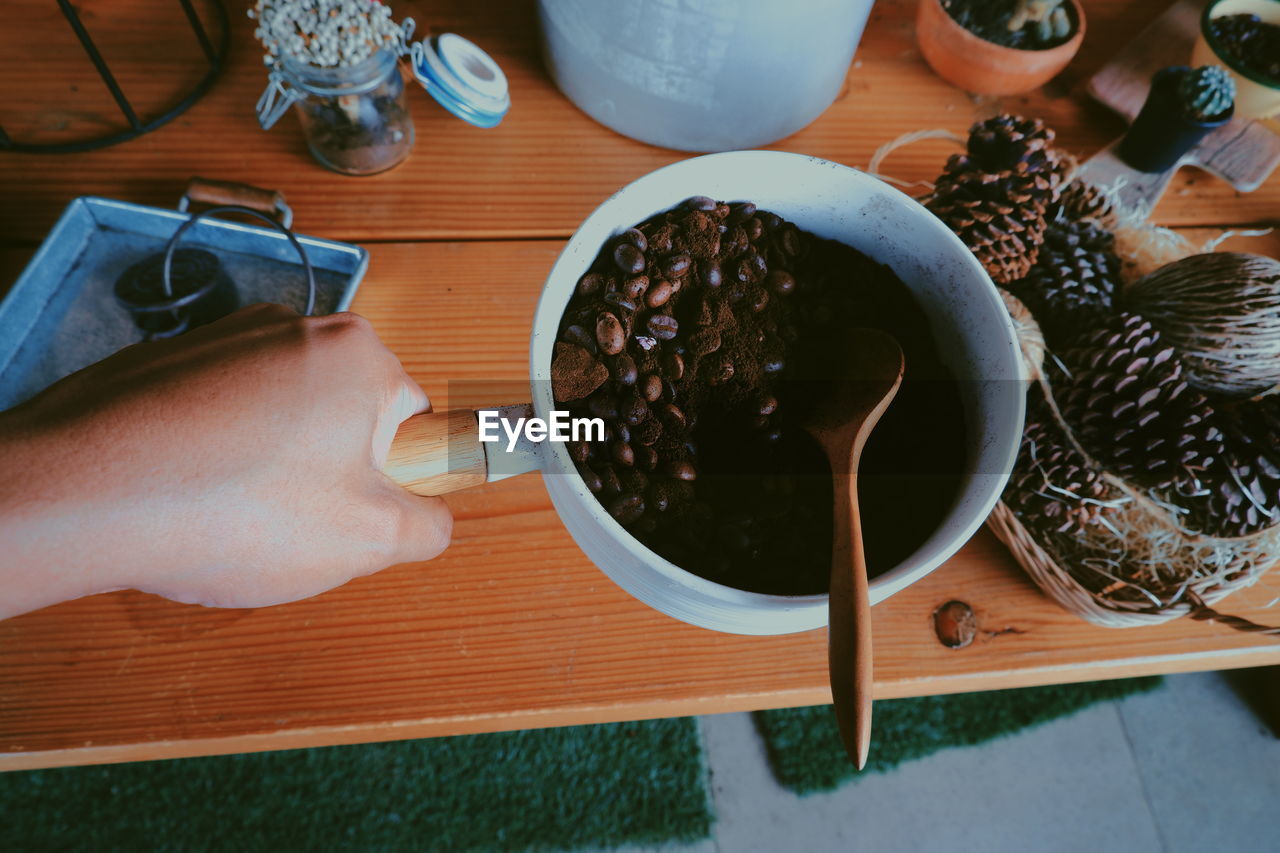 High angle view of hand holding food on table