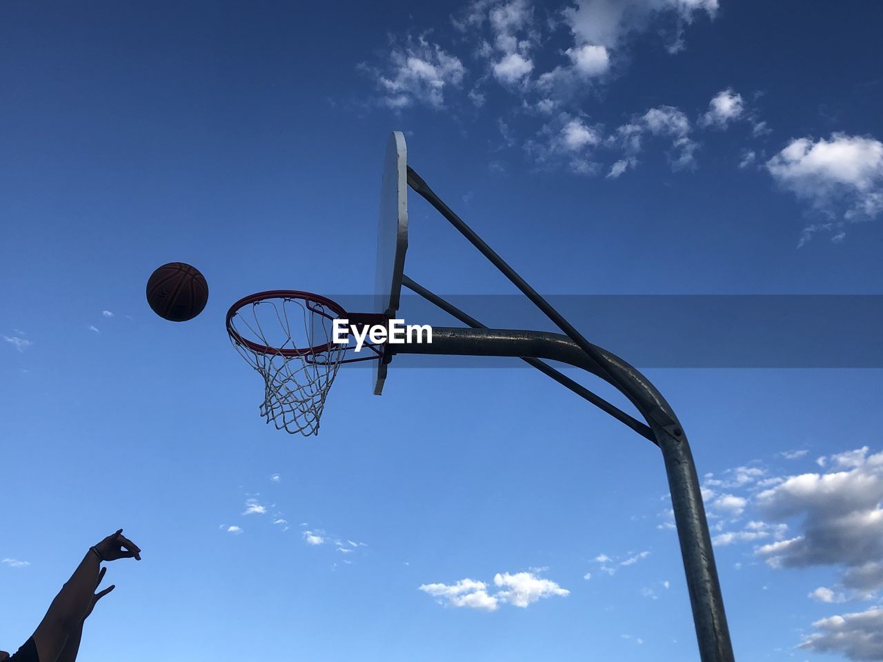 low angle view of basketball hoop against blue sky
