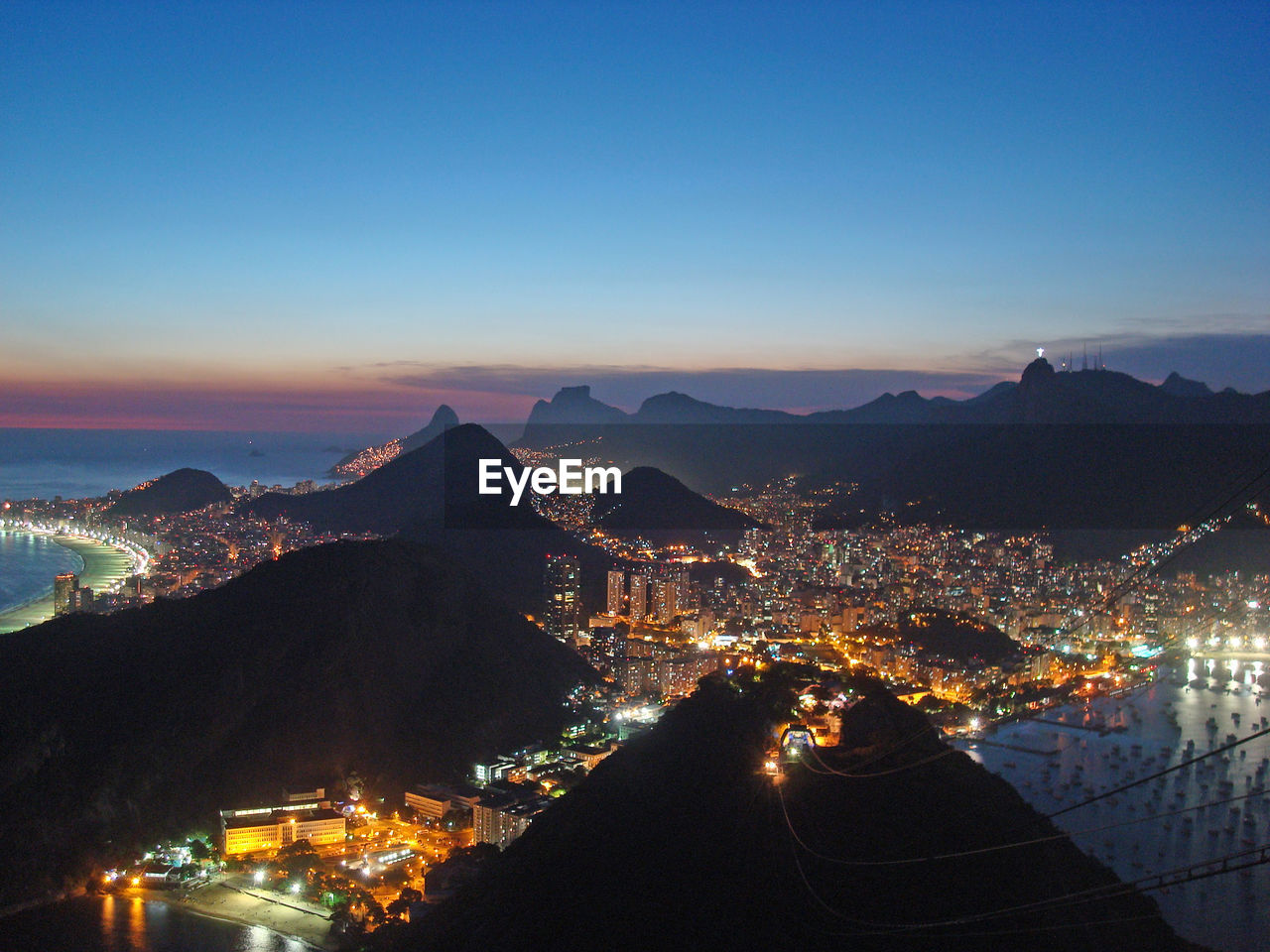 High angle view of city lit up at night