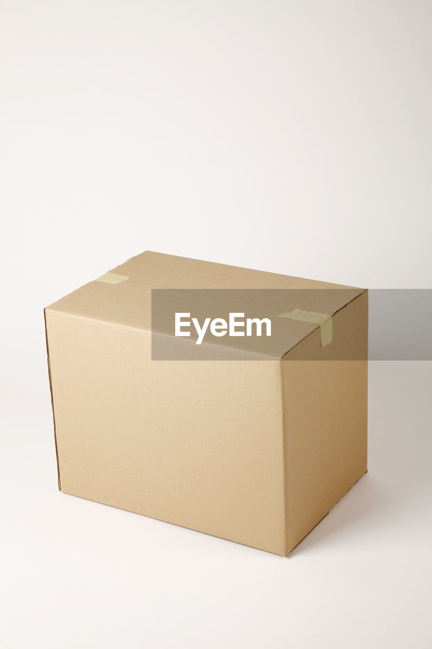 High angle view of brown cardboard box against white background