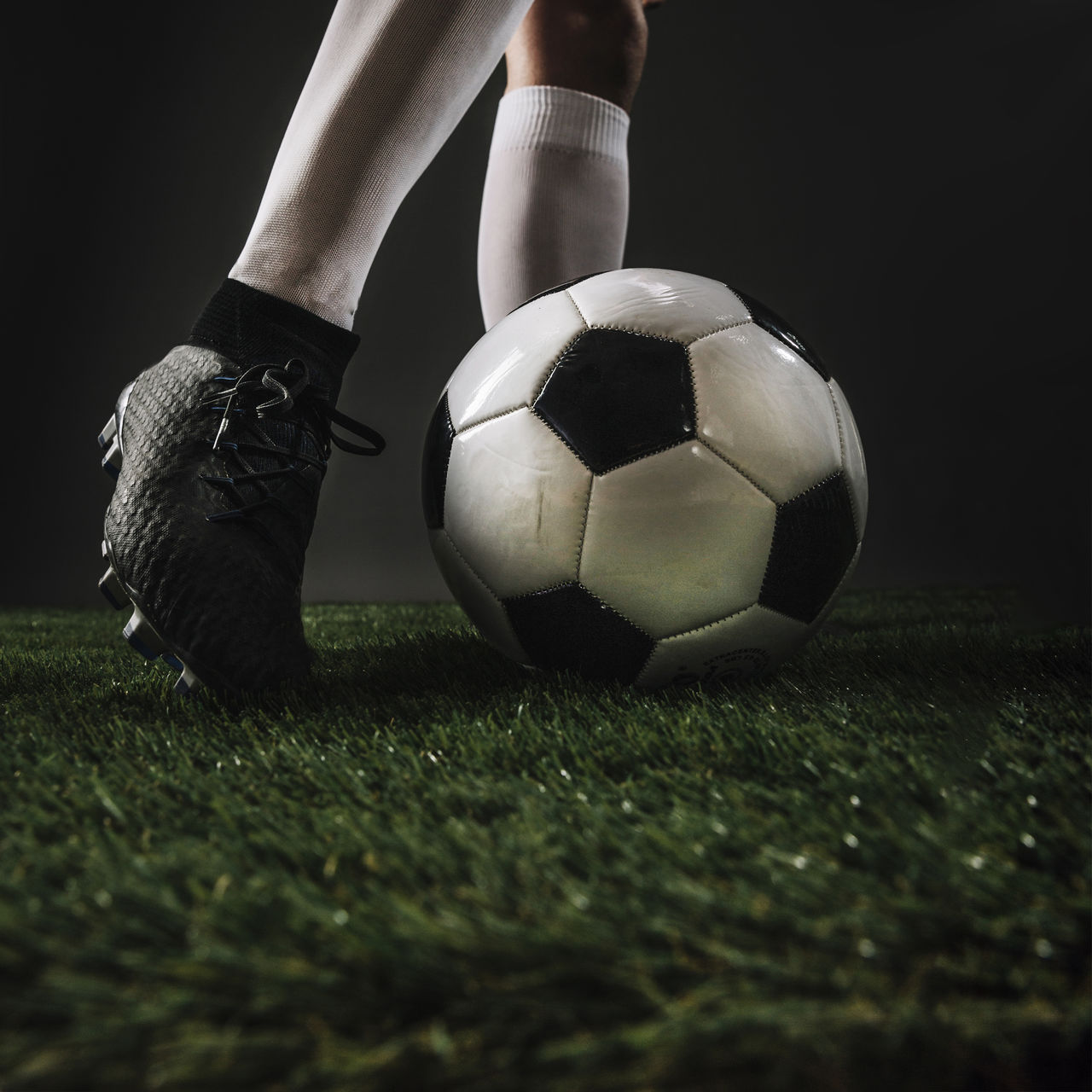 low section of man playing soccer on field