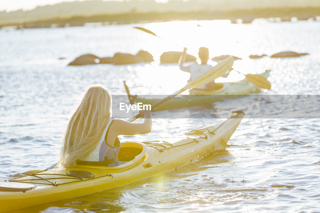 Women kayaking at evening