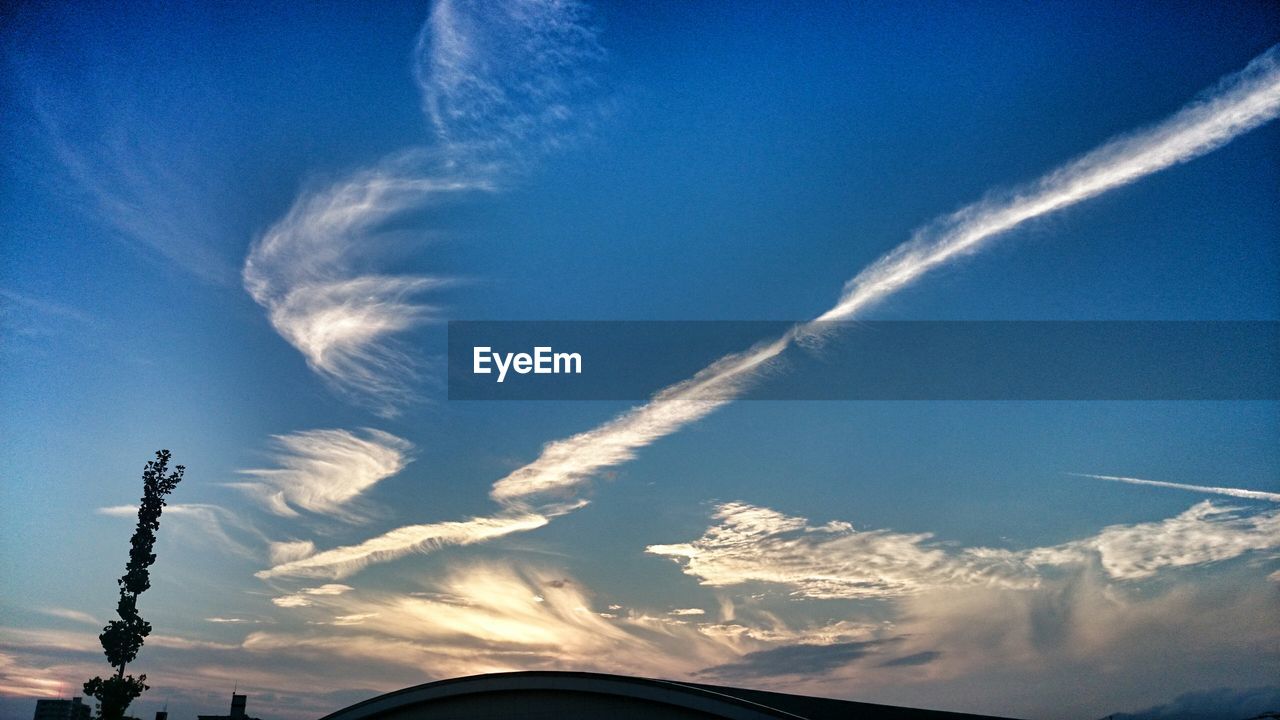 Low angle view of vapor trails in sky