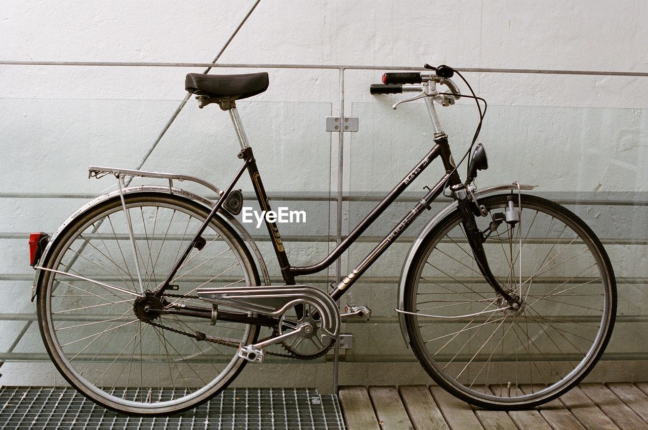 BICYCLE PARKED AGAINST WALL