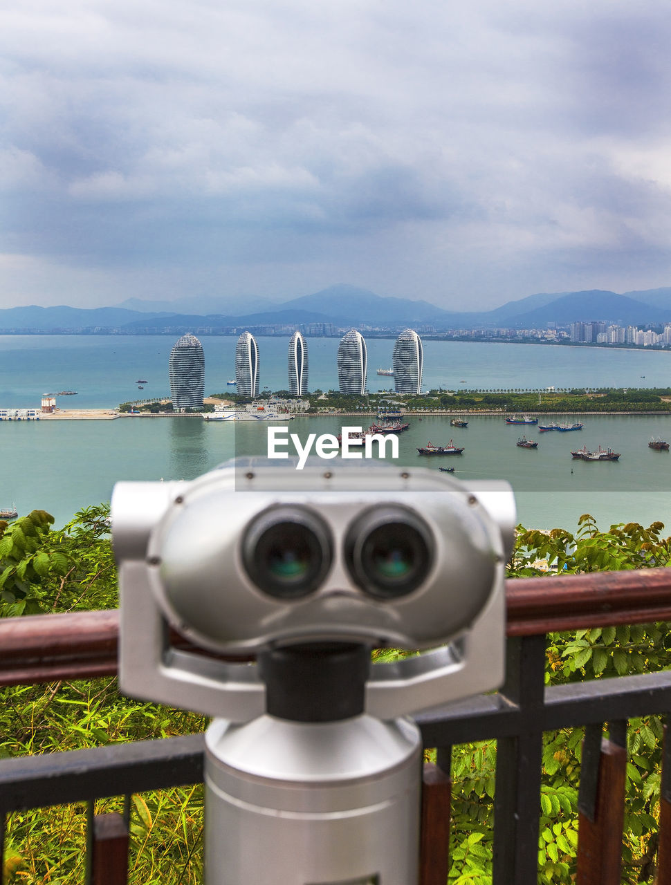 Binoculars for viewing the panorama of the city. sanya phoenix island president resort apartment