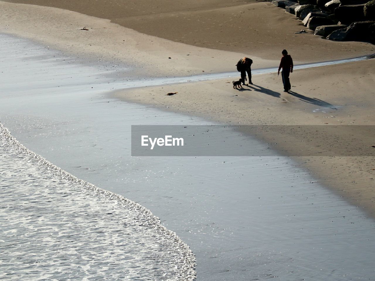 MEN WALKING AT BEACH