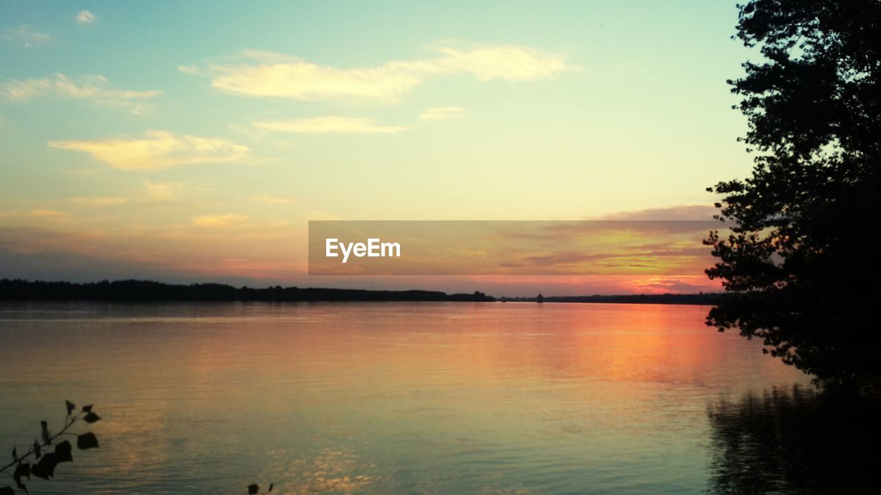 Scenic view of lake against sky during sunset