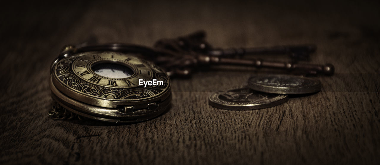 Close-up of pocket watch on table
