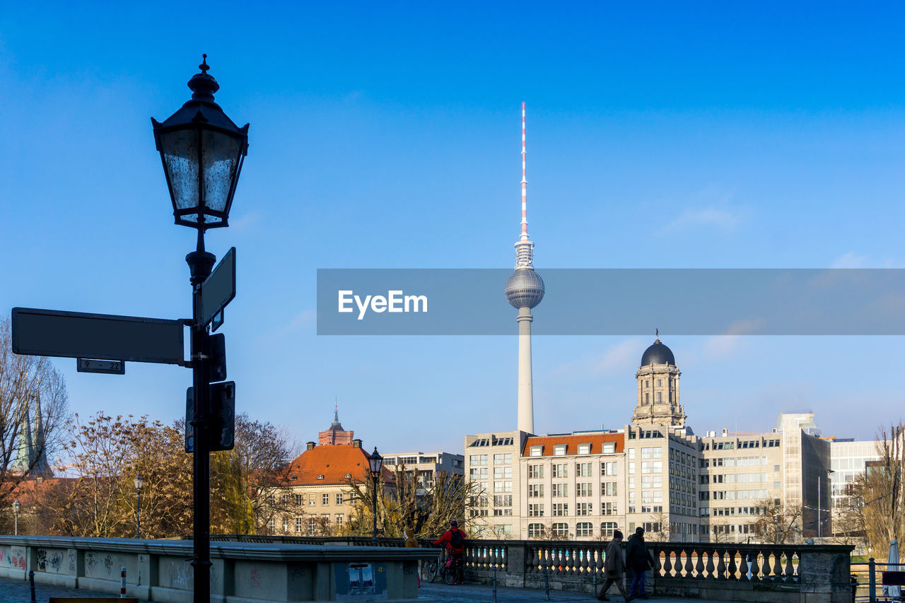 Fernsehturm against blue sky in city