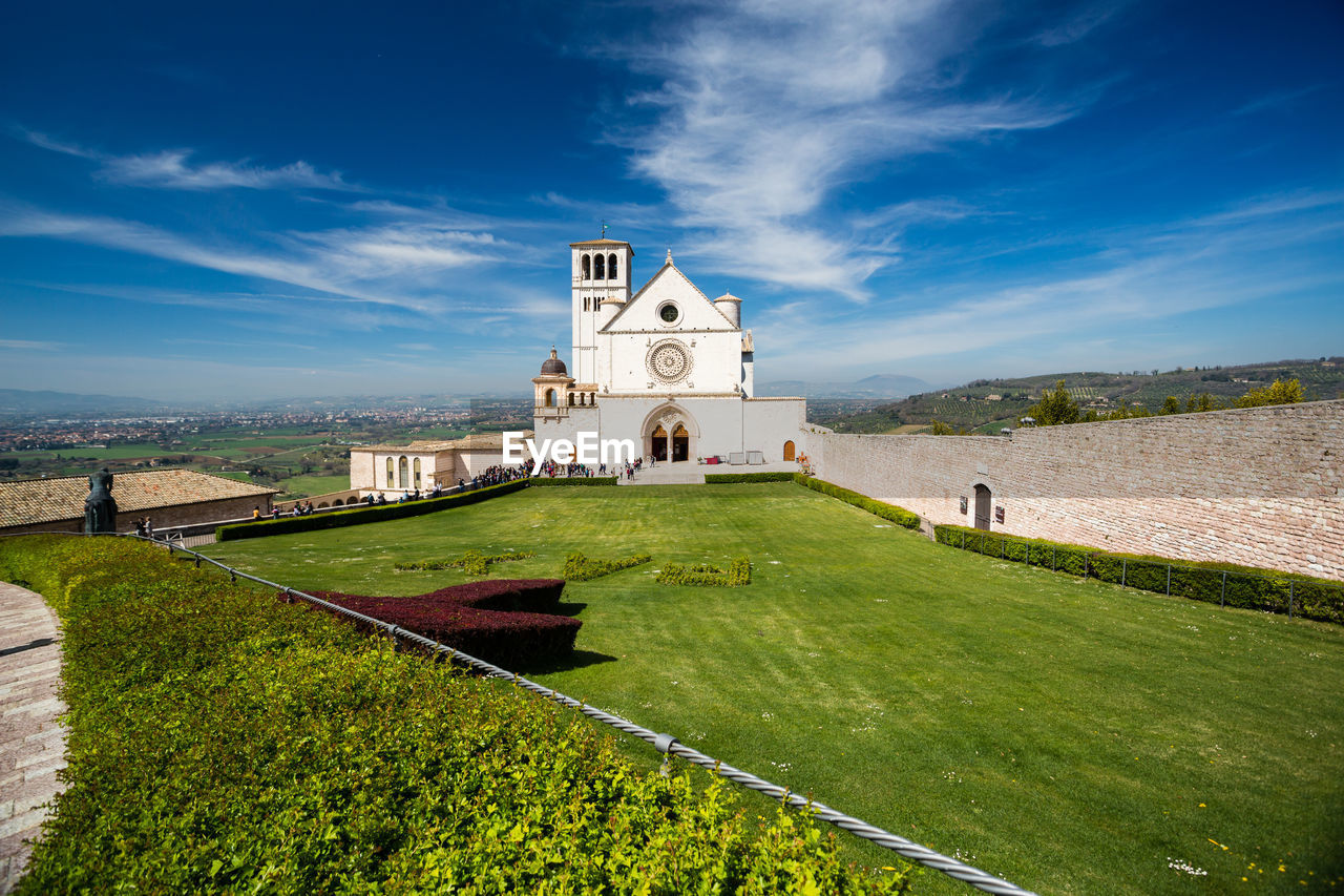 CHURCH AMIDST BUILDINGS AGAINST SKY