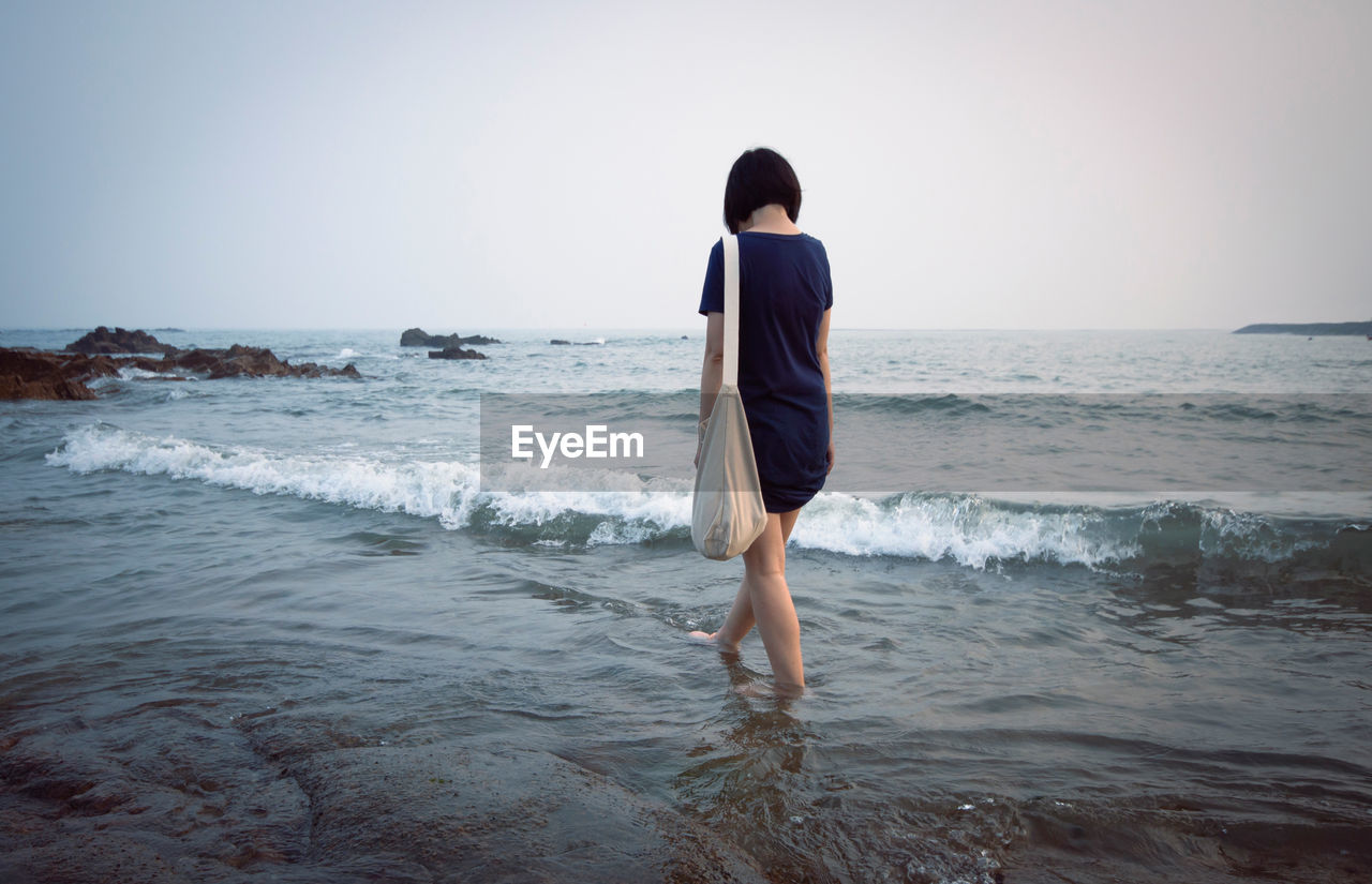 Full length of woman walking on beach 