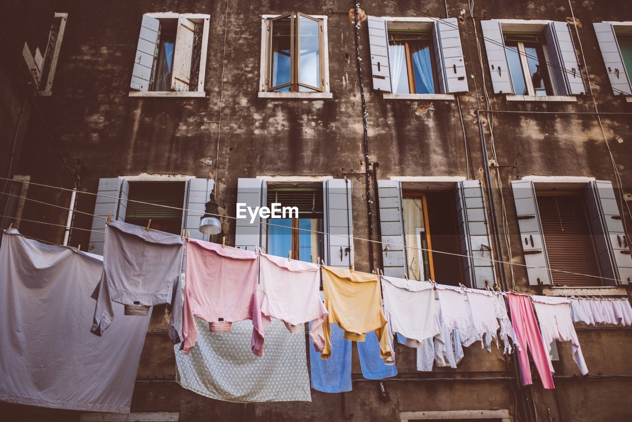 LOW ANGLE VIEW OF CLOTHES HANGING ON CLOTHESLINE