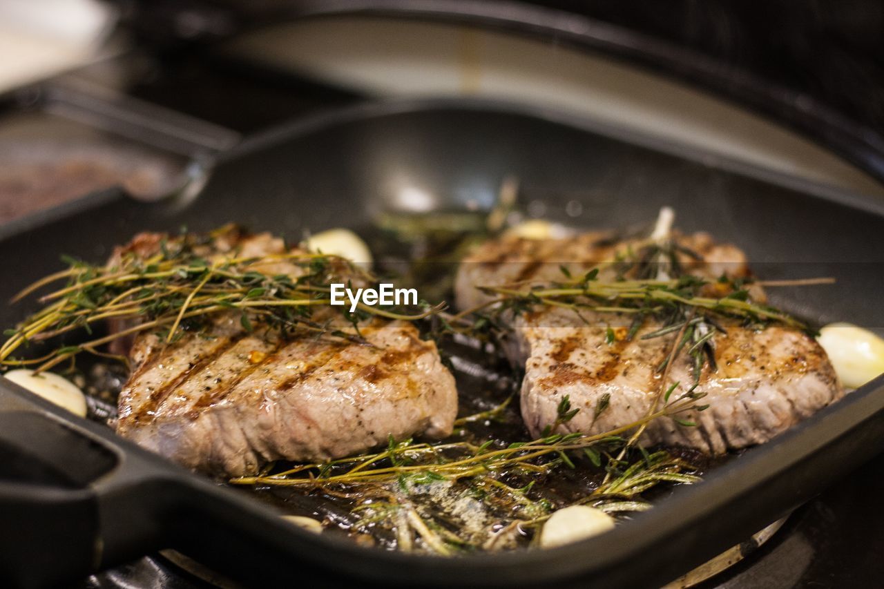 High angle view of steak being grilled on stove