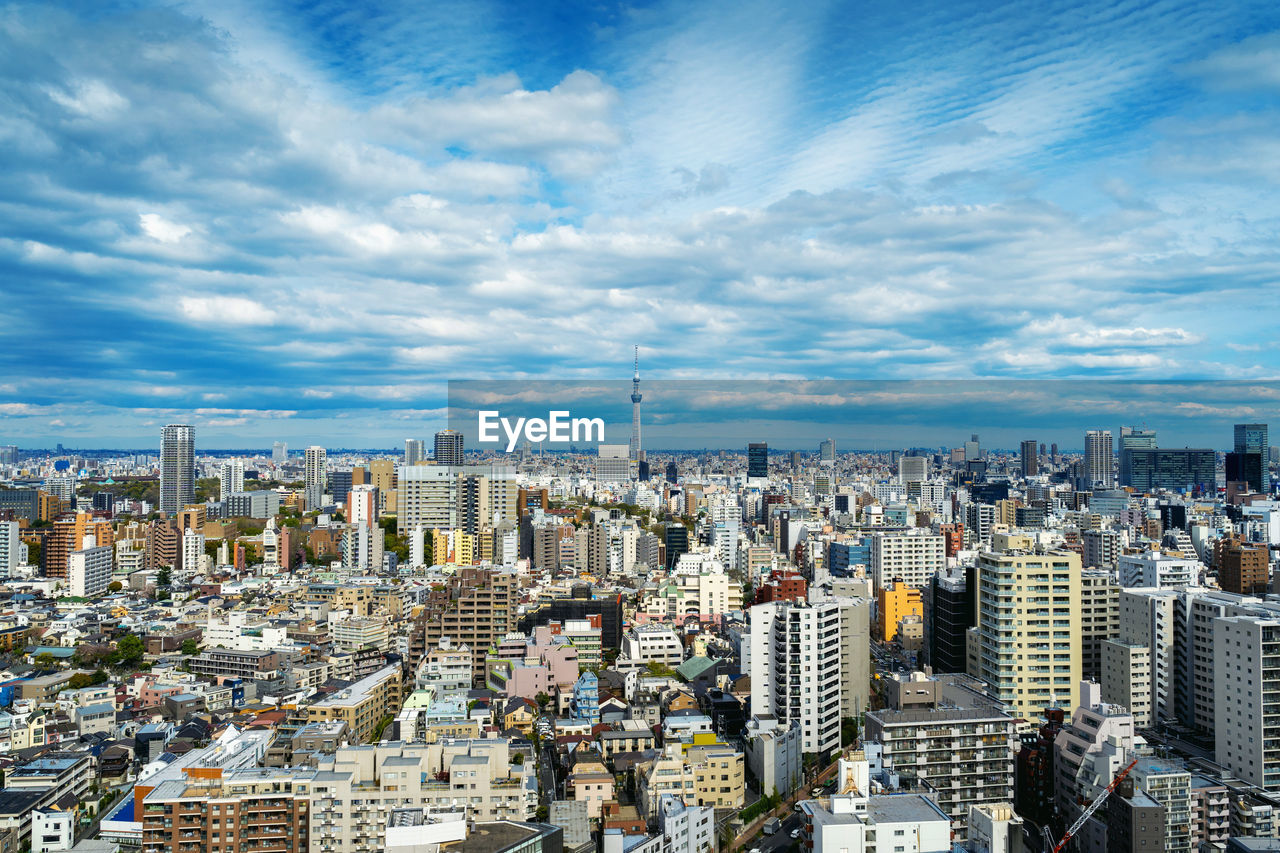 Aerial view of modern buildings in city against sky