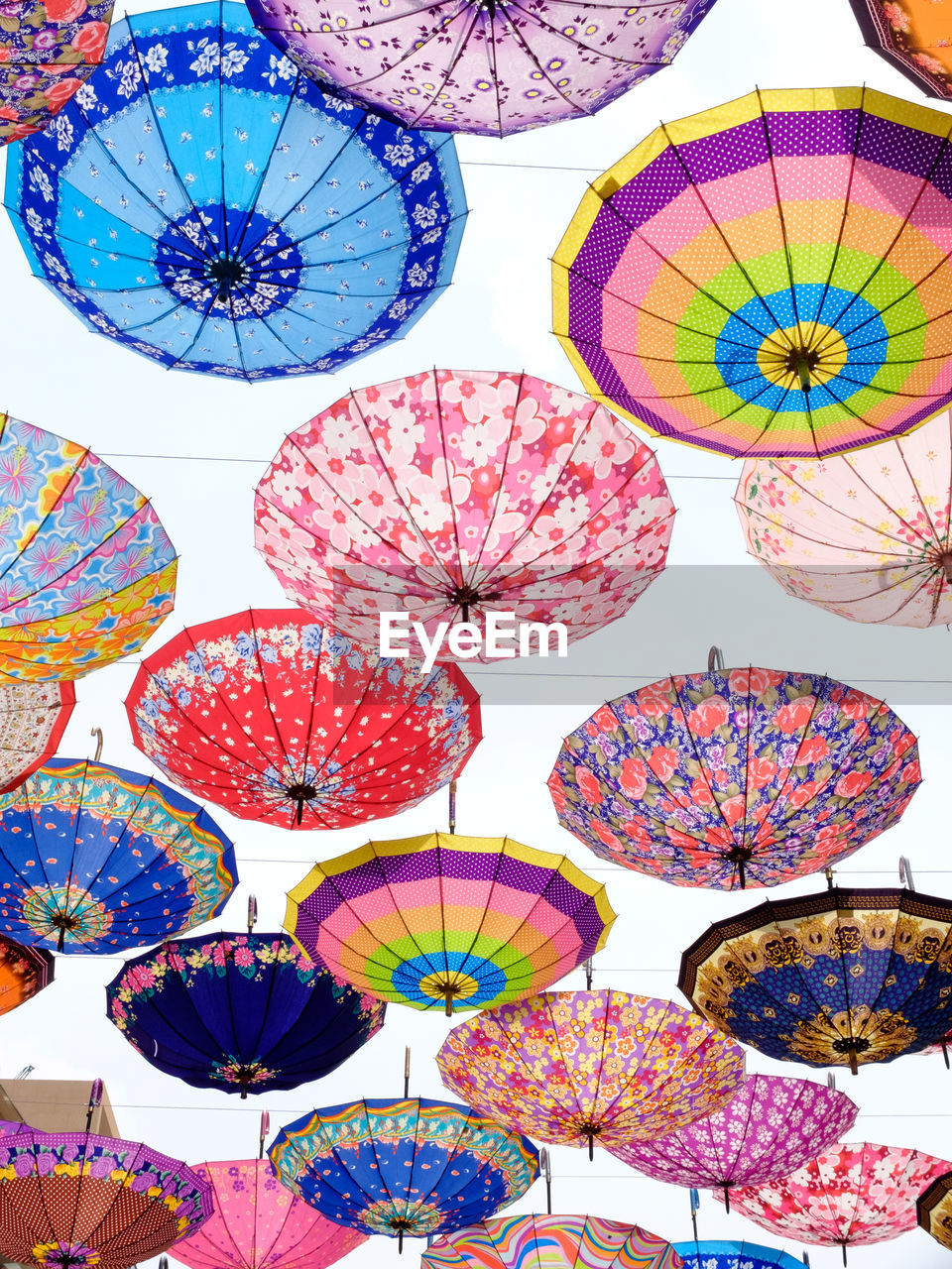 Low angle view of colorful umbrellas against sky