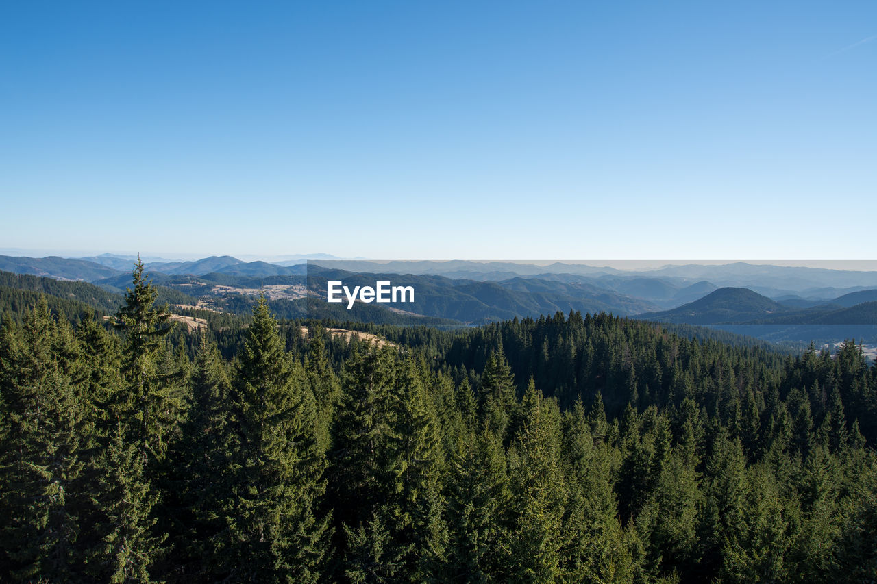 Scenic view of mountains against clear blue sky