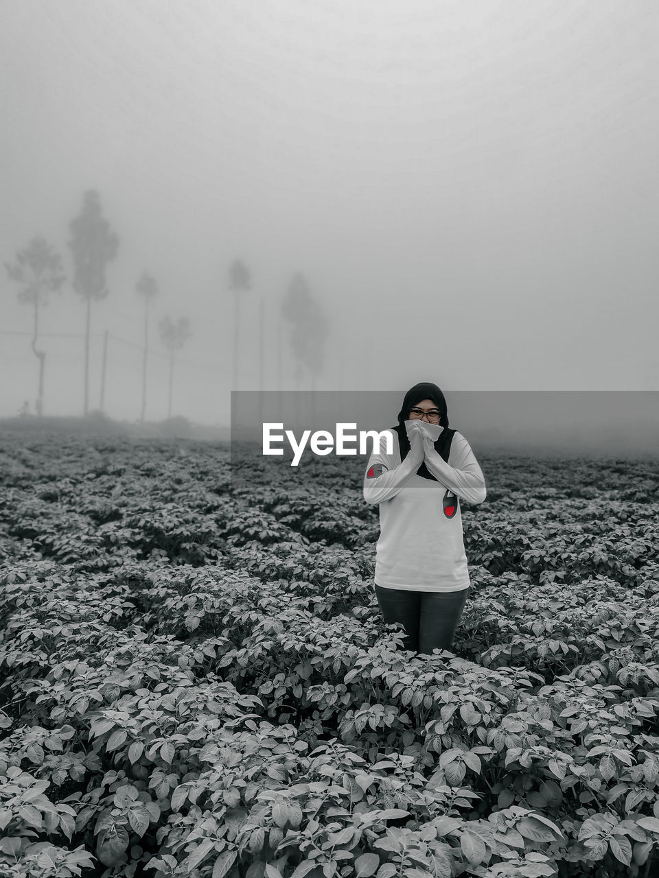 fog, one person, white, nature, land, winter, women, full length, black and white, adult, environment, clothing, standing, sky, snow, young adult, front view, mist, monochrome, cold temperature, female, monochrome photography, portrait, day, outdoors, lifestyles, sea, beauty in nature, landscape, copy space, horizon, plant, leisure activity, field, morning, childhood, looking at camera, child, emotion, person
