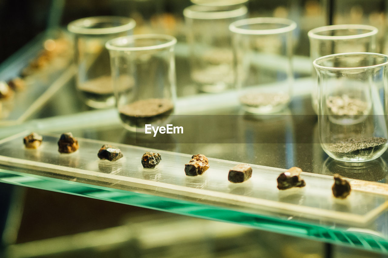 Close-up of glasses and stones on table