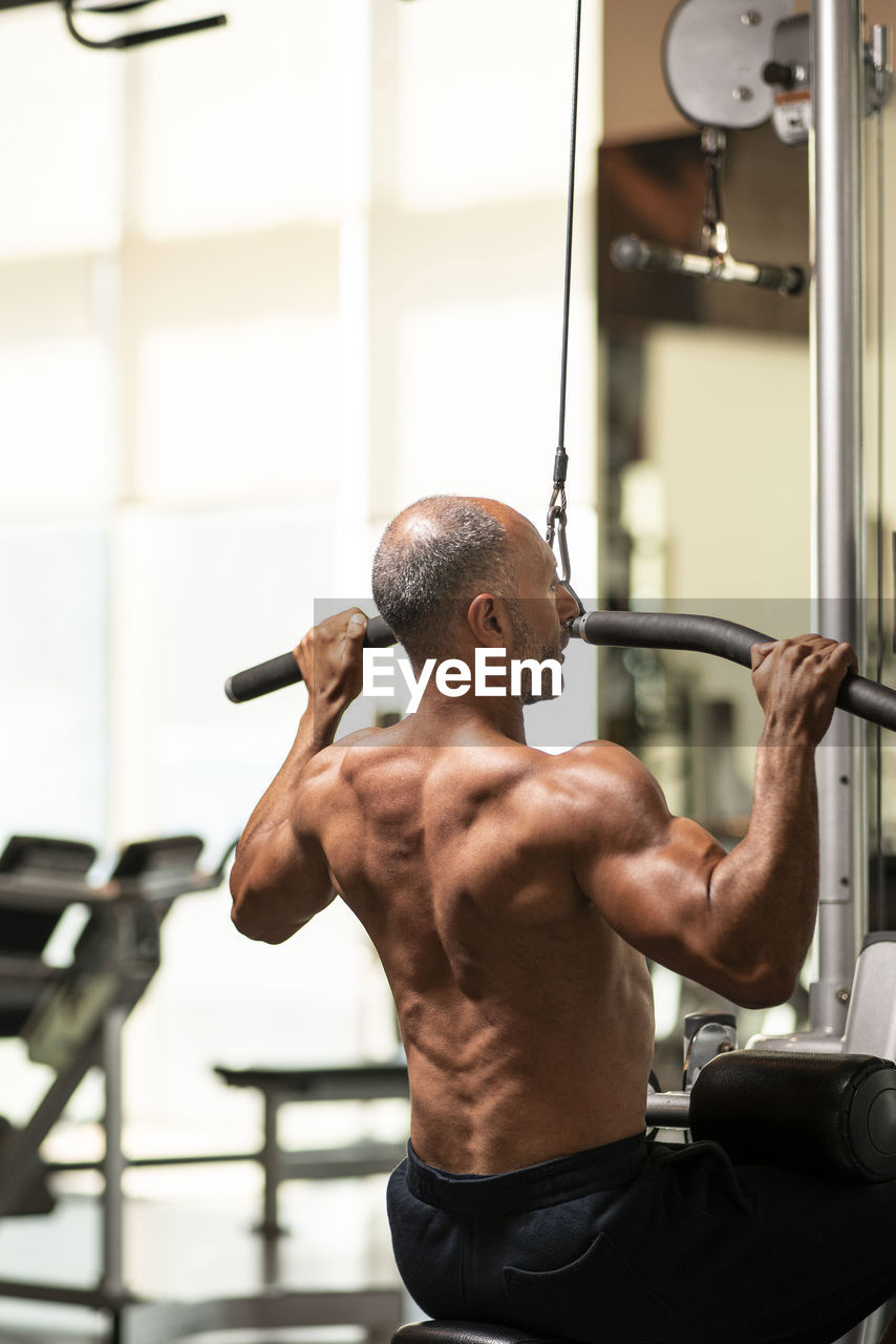 Mature man exercising in gym