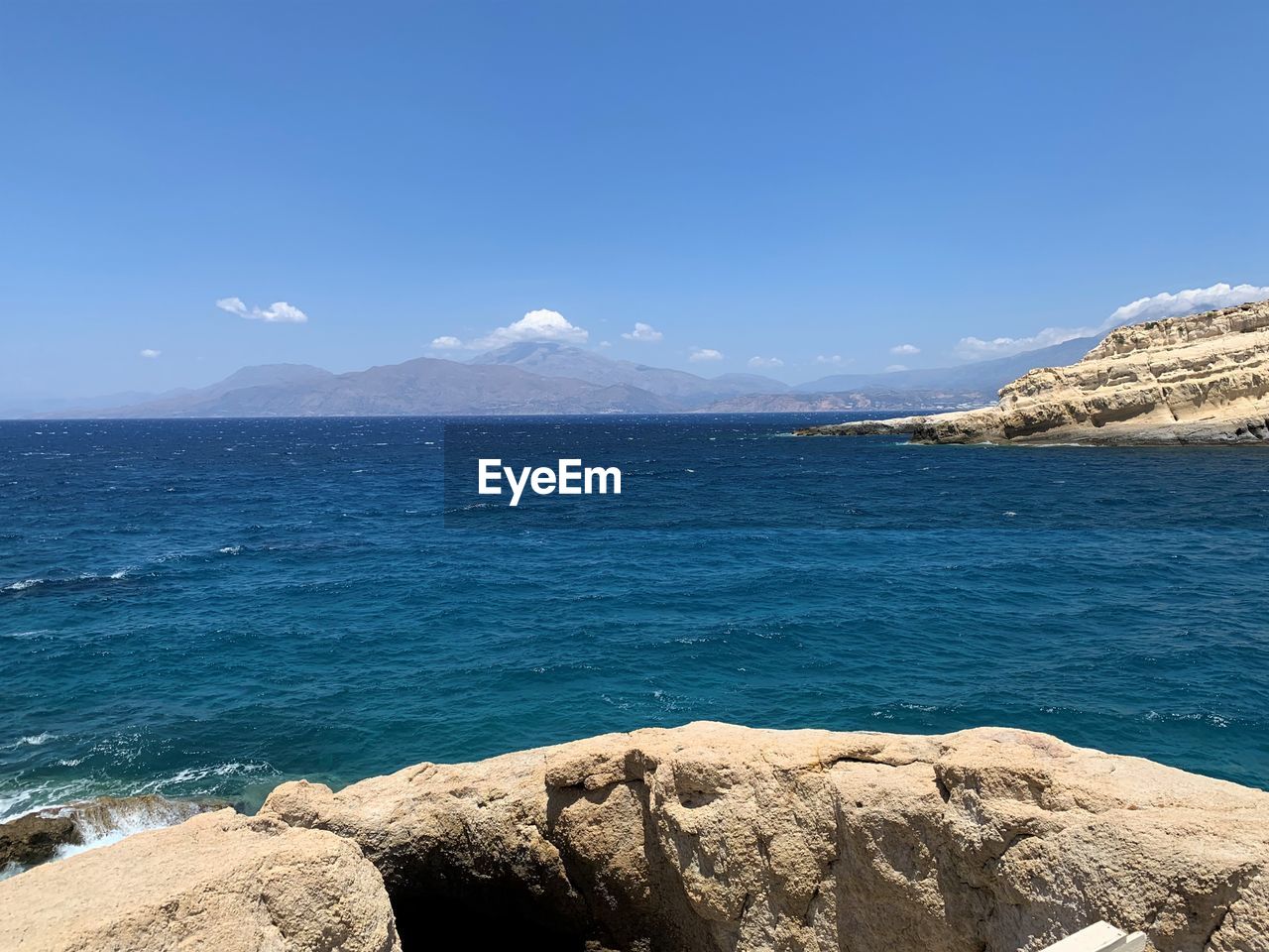 Scenic view of sea against blue sky