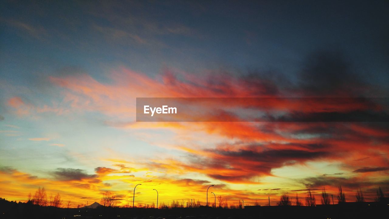 Silhouette landscape against scenic sky