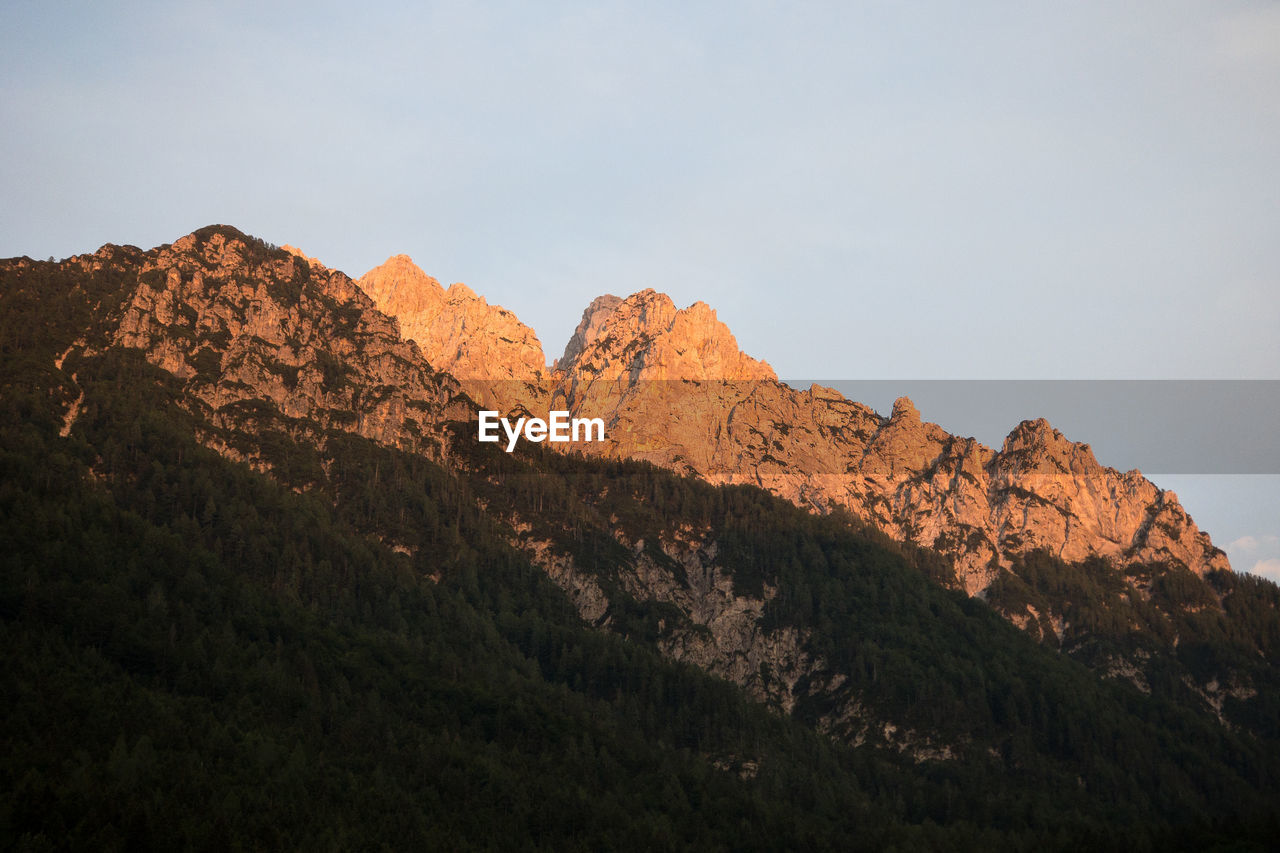 Low angle view of rocky mountains against sky