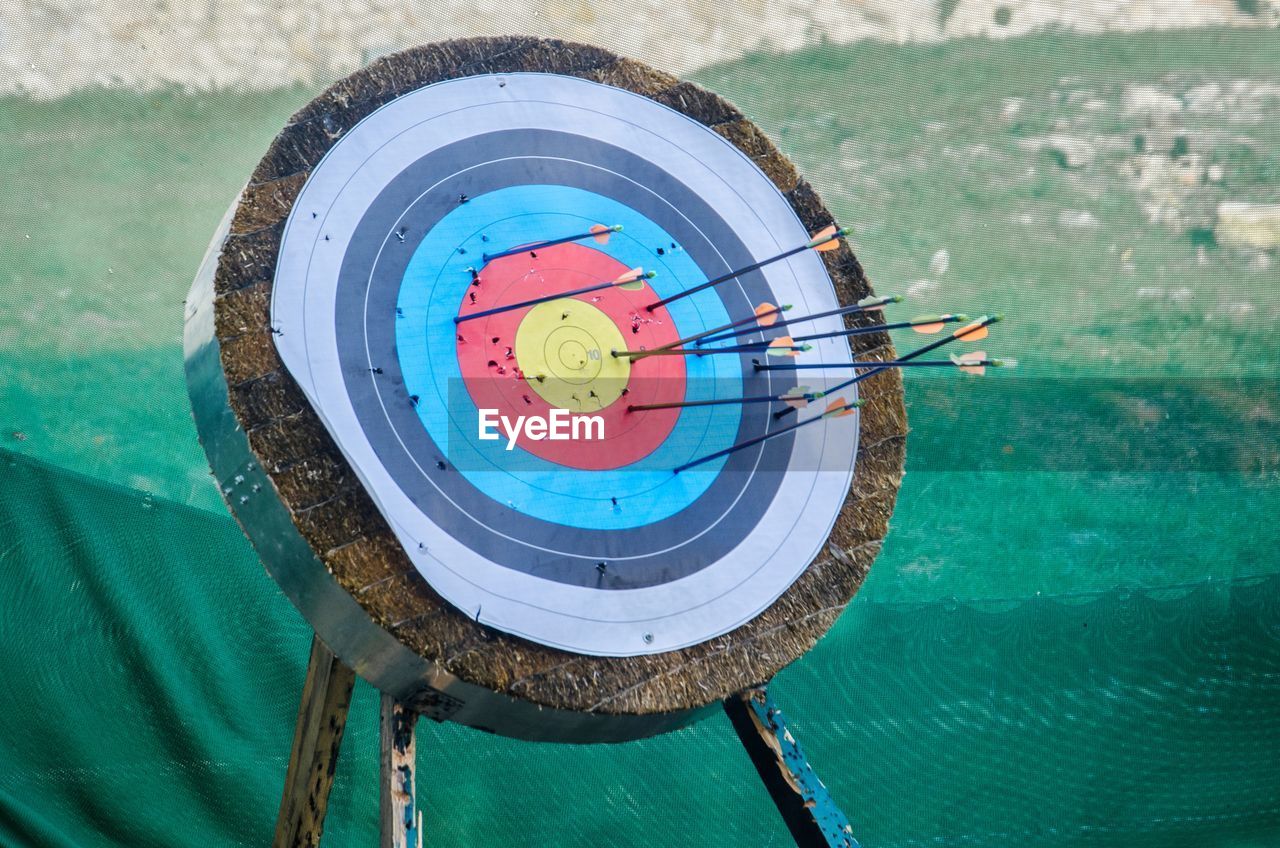 Arrows on sports target against net