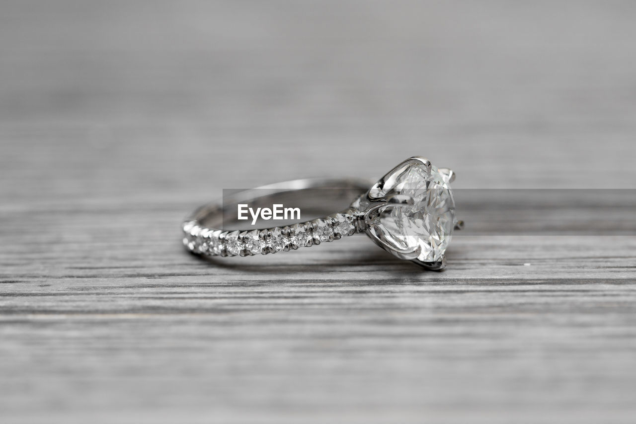 Close-up of diamond ring on table