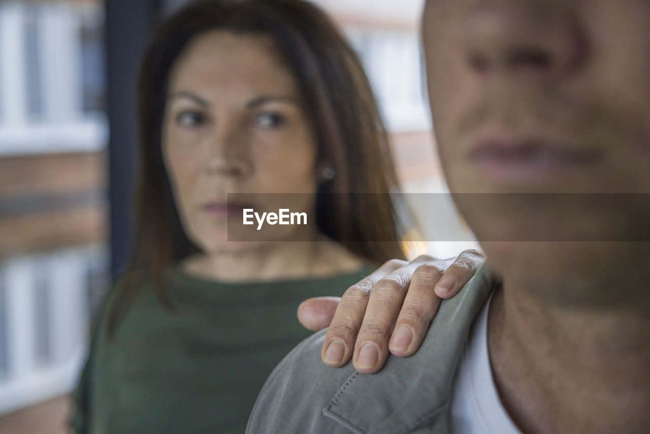 Mature woman touching man's arm