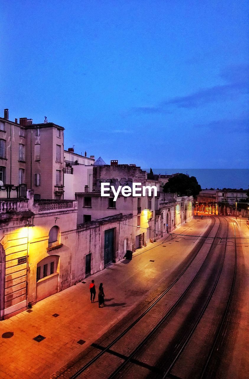 BUILDINGS IN CITY AGAINST SKY AT DUSK