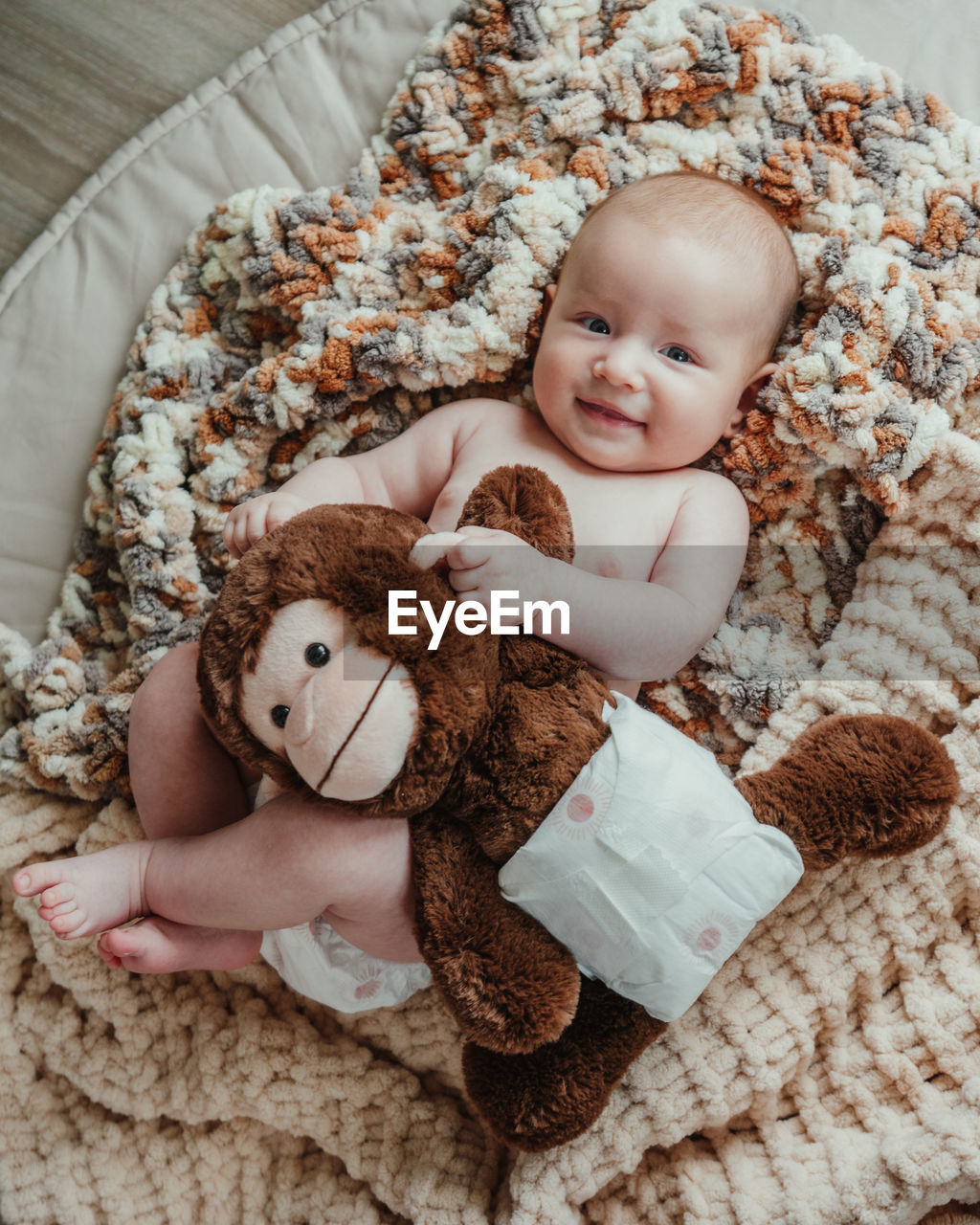 Portrait of cute baby boy lying down toy