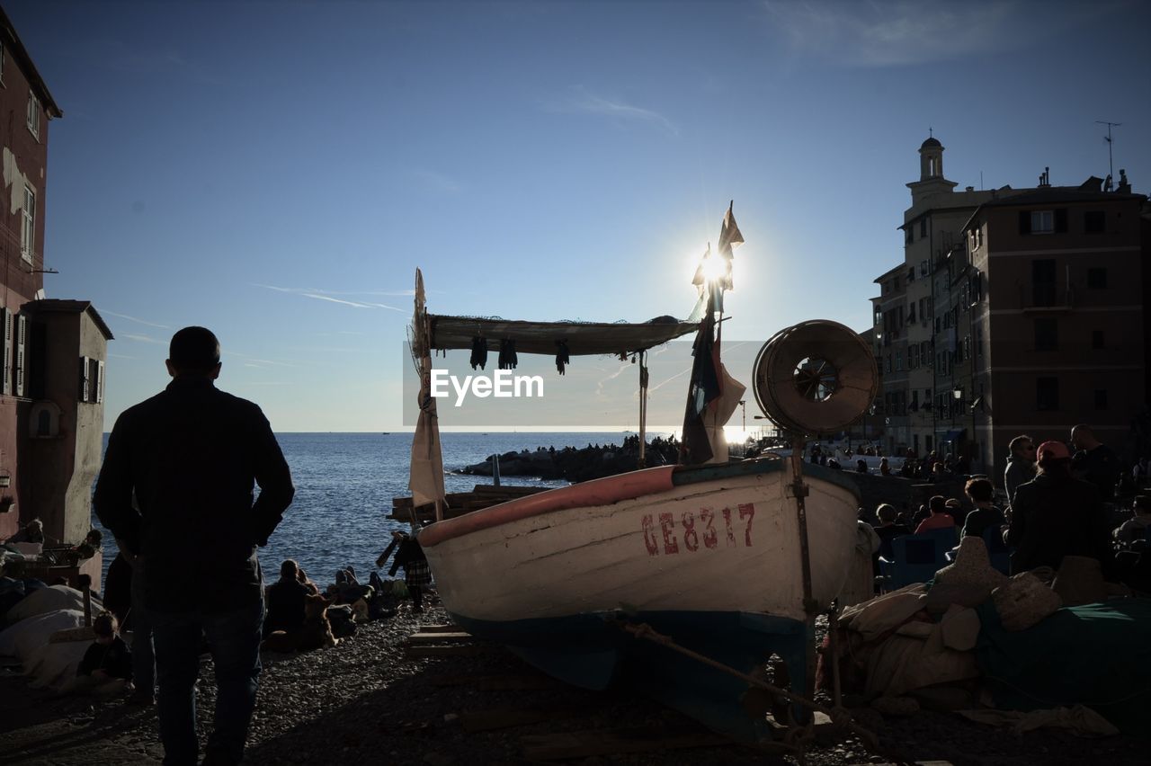 People by boat at beach in camogli