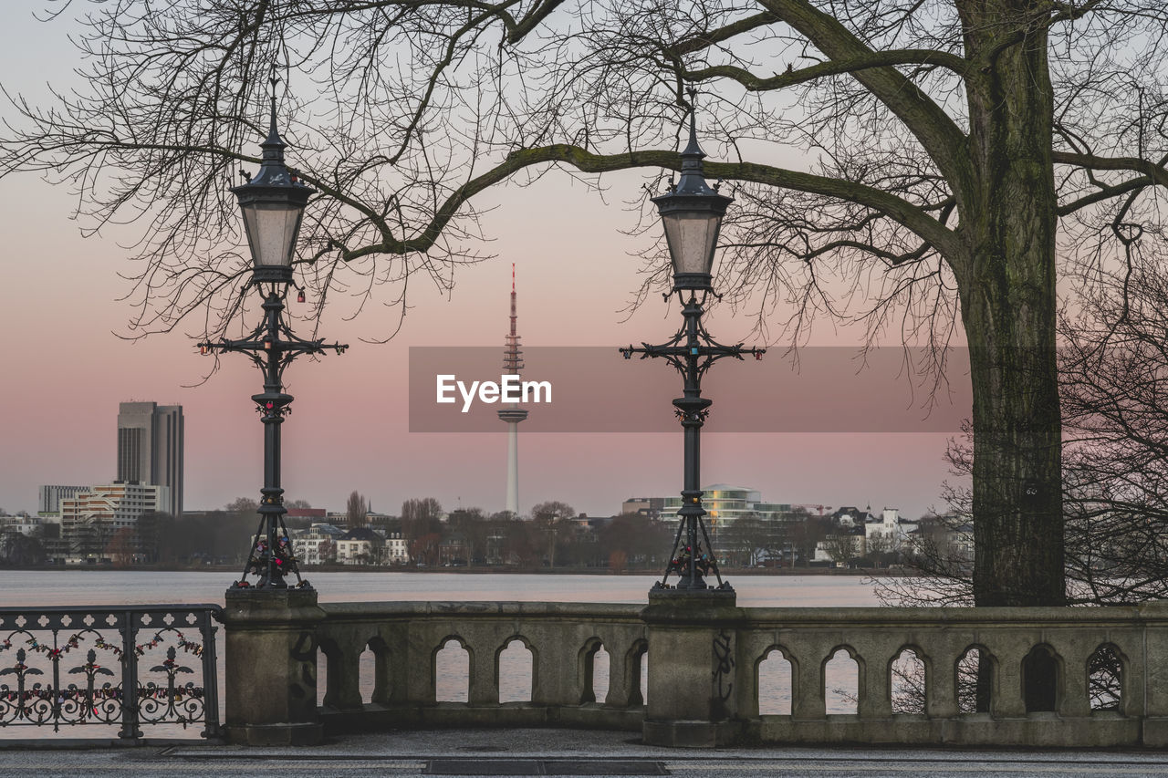 Germany, hamburg, street lights of schwanenwikbrucke bridge at dusk