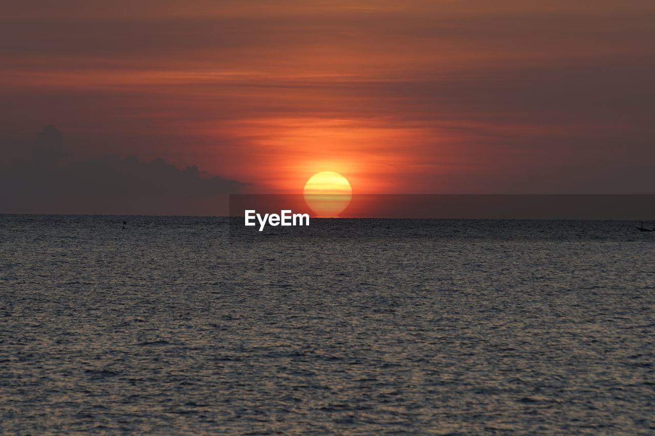 Scenic view of sea against romantic sky at sunset