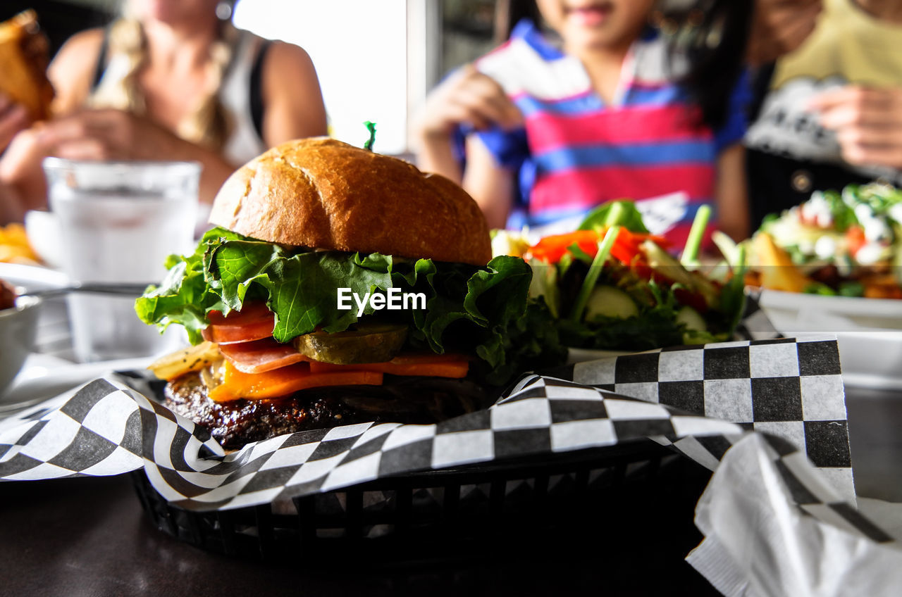 Close-up of food on table with people in background