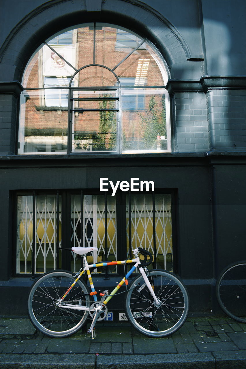 Bicycle parked in front of building