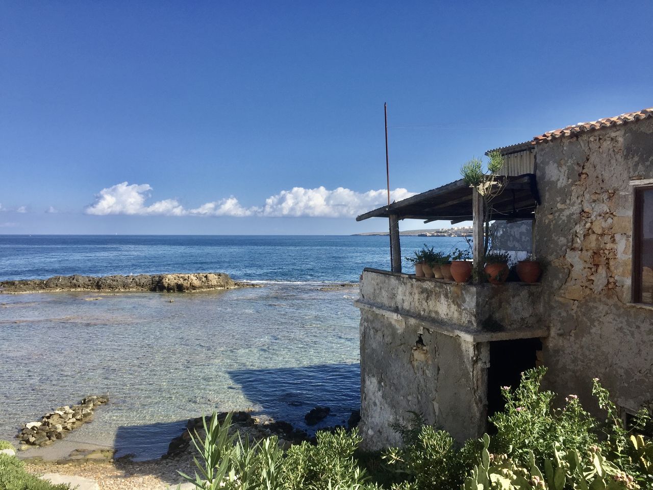 Scenic view of sea against blue sky