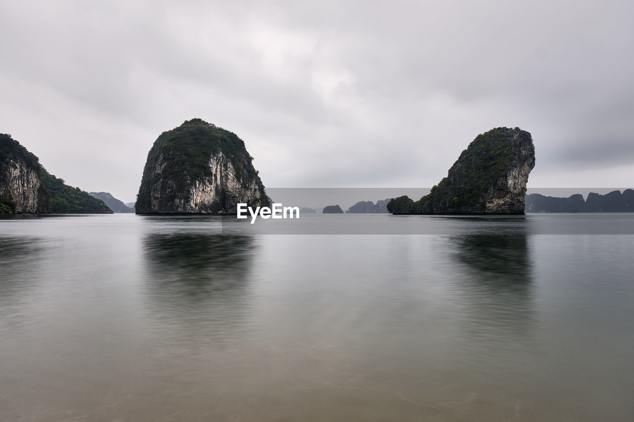 Rocks in sea against sky