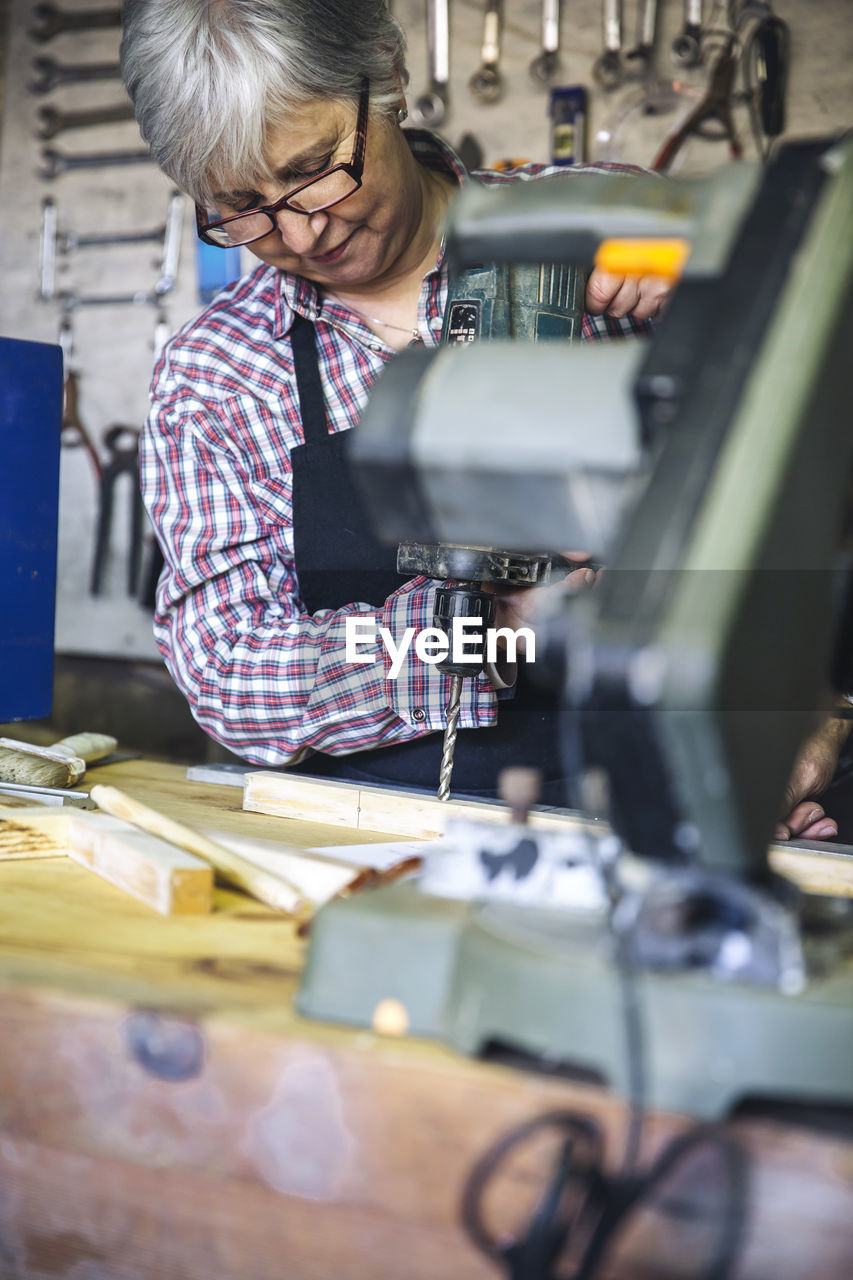 Senior woman working in factory