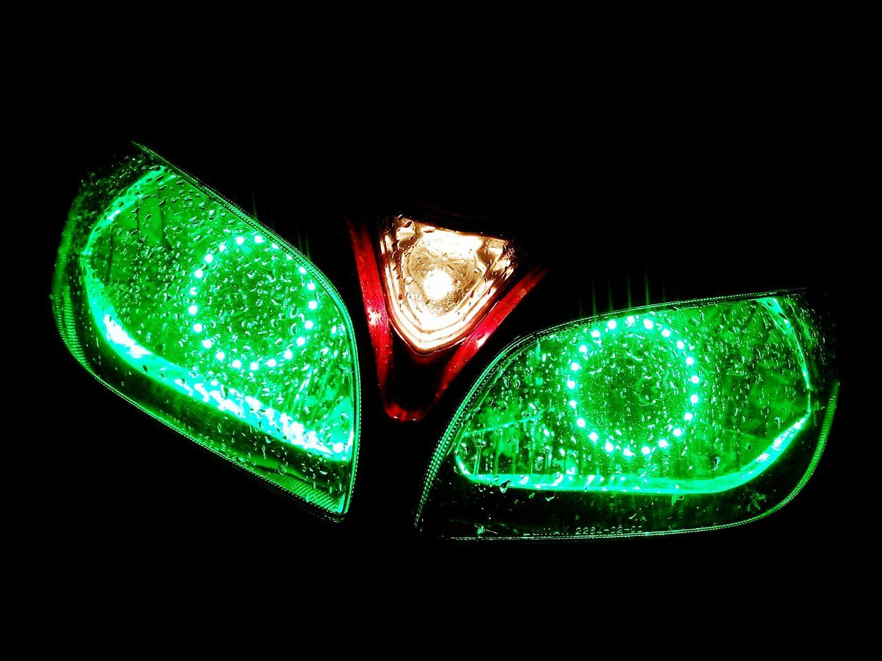 Close-up of illuminated motorcycle headlights