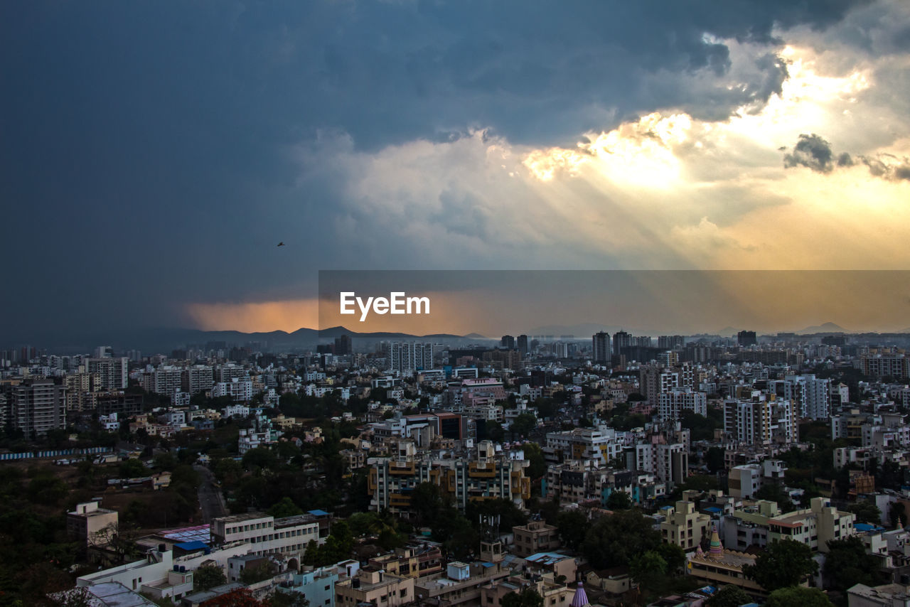 HIGH ANGLE VIEW OF CITYSCAPE AT SUNSET