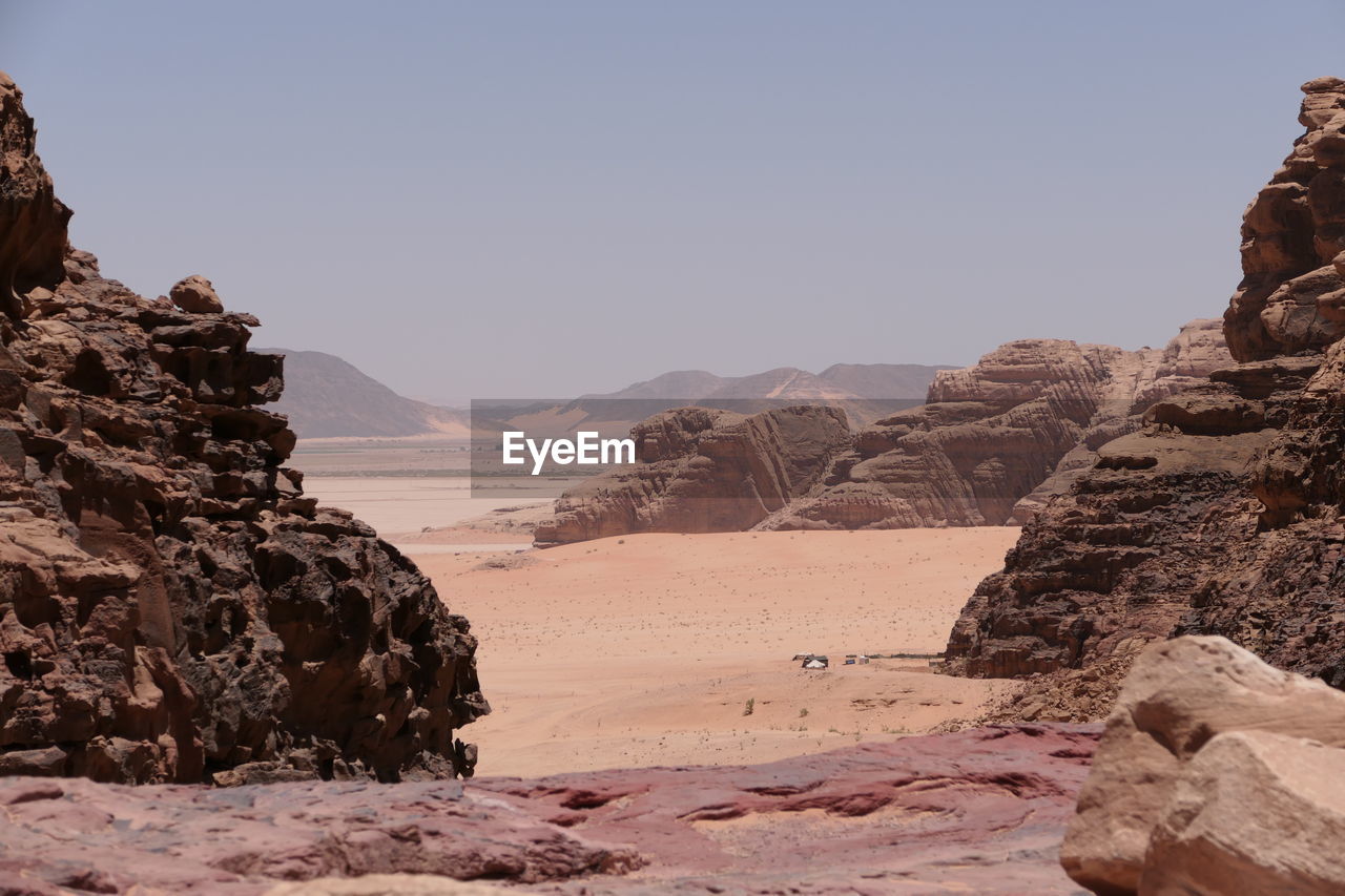 Rock formations on landscape in wadi rum against clear sky