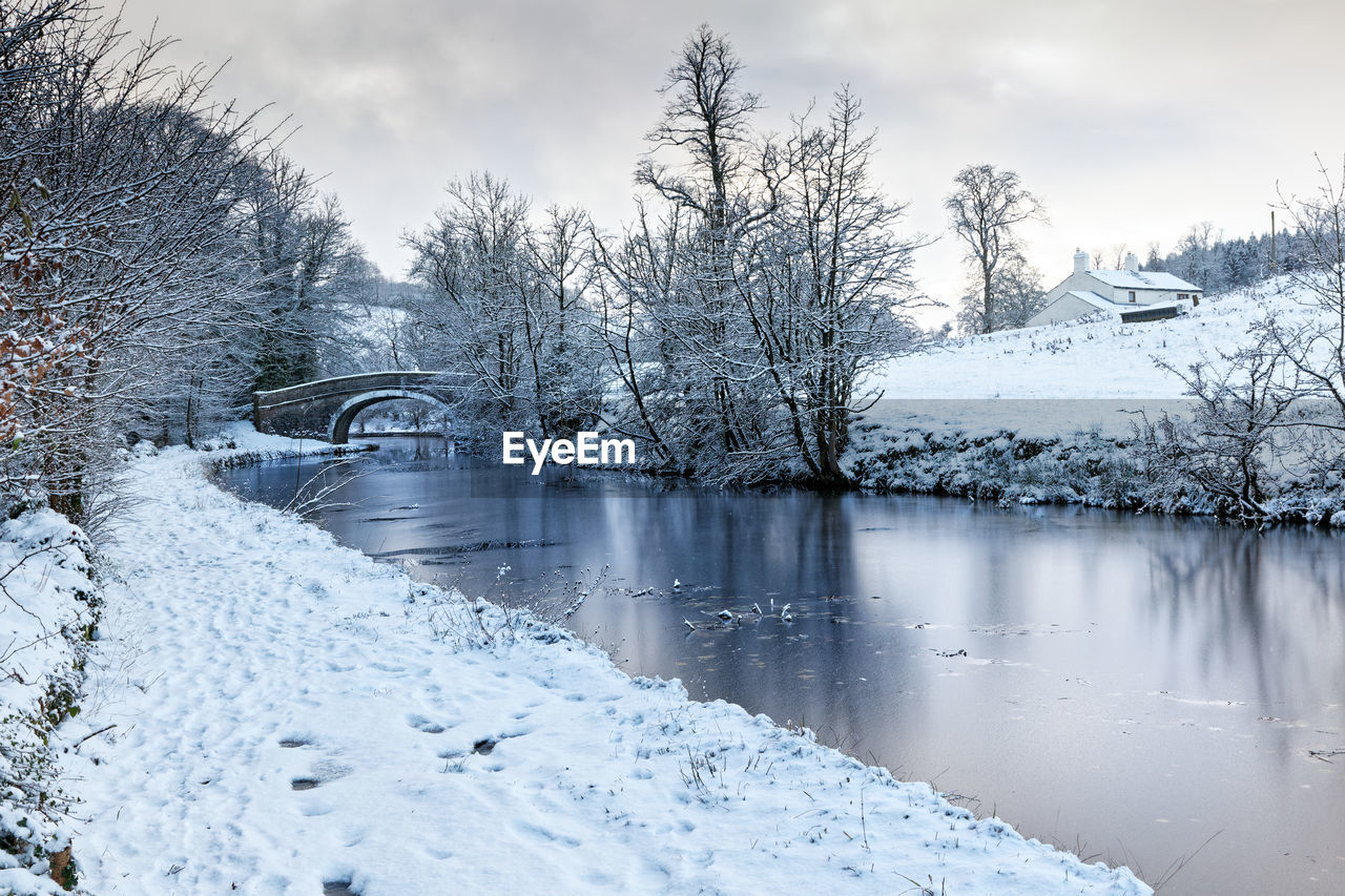 winter, snow, cold temperature, tree, water, nature, scenics - nature, plant, landscape, environment, freezing, beauty in nature, frost, sky, forest, frozen, cloud, tranquil scene, tranquility, land, coniferous tree, no people, pinaceae, pine tree, reflection, non-urban scene, lake, woodland, pine woodland, ice, white, travel destinations, rural scene, mountain, architecture, outdoors, travel, polar climate, overcast, day, idyllic, fog, tourism, branch